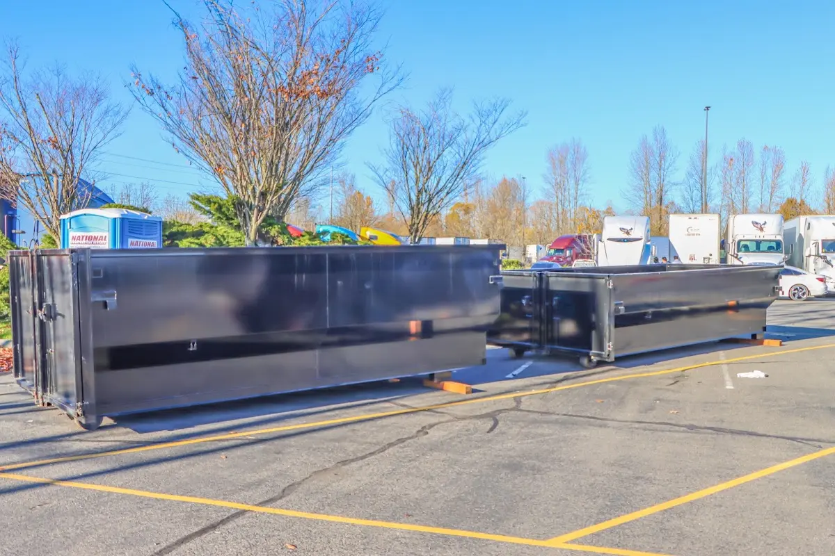 Professional dumpster rental service with roll-off container on residential driveway in Kailua-Kona